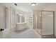 Bright bathroom featuring corner glass block windows, a vanity, and a glass enclosed shower at 9185 Old Southwick Pass, Johns Creek, GA 30022