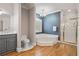 Bathroom with a jacuzzi tub, separate shower, gray vanity with a granite countertop, and hardwood floors at 9185 Old Southwick Pass, Johns Creek, GA 30022