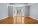 Spacious bedroom features gleaming hardwood floors, crown molding, and a bay window nook with shuttered windows at 9185 Old Southwick Pass, Johns Creek, GA 30022