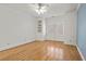 Bright bedroom features hardwood floors, built-in shelves, crown molding, and a large window with plantation shutters at 9185 Old Southwick Pass, Johns Creek, GA 30022