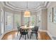 Cozy dining area with a stylish chandelier, natural light, and hardwood floors at 9185 Old Southwick Pass, Johns Creek, GA 30022