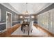 Sophisticated dining room with hardwood floors, tray ceiling, and plantation shutters at 9185 Old Southwick Pass, Johns Creek, GA 30022
