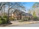 Expansive brick home with a grand entrance and a lush, green lawn at 9185 Old Southwick Pass, Johns Creek, GA 30022