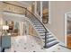 Spacious foyer featuring a grand staircase, marble floors, and elegant architectural details at 9185 Old Southwick Pass, Johns Creek, GA 30022