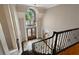 Grand foyer with a soaring ceiling, large arched window, beautiful chandelier, and decorative wrought iron staircase at 9185 Old Southwick Pass, Johns Creek, GA 30022