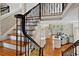 Open concept foyer view showcases staircase with wooden treads and black metal railings at 9185 Old Southwick Pass, Johns Creek, GA 30022
