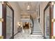 Grand foyer with marble floors, a striking staircase, and elegant lighting fixture at 9185 Old Southwick Pass, Johns Creek, GA 30022