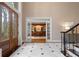 Open foyer with marble floors, grand entry door, and view into the office area at 9185 Old Southwick Pass, Johns Creek, GA 30022