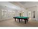 Spacious game room with a beautiful pool table and lighting; lovely shuttered windows for natural light at 9185 Old Southwick Pass, Johns Creek, GA 30022