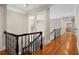 Hallway with hardwood floors, crown molding, and access to multiple rooms, connecting different parts of the house at 9185 Old Southwick Pass, Johns Creek, GA 30022