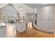 Open kitchen with a large island, stainless steel appliances, and natural light from a large window at 9185 Old Southwick Pass, Johns Creek, GA 30022