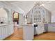 Bright kitchen featuring white cabinets, stainless steel appliances, and a large arched window at 9185 Old Southwick Pass, Johns Creek, GA 30022