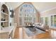 Elegant living room with a high vaulted ceiling, fireplace, and large windows at 9185 Old Southwick Pass, Johns Creek, GA 30022