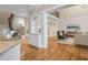 Open living area with hardwood floors, a bar, and views of the grand staircase at 9185 Old Southwick Pass, Johns Creek, GA 30022