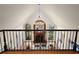 Living room with large windows, hardwood floors, a fireplace, and a chandelier, viewed from the second floor at 9185 Old Southwick Pass, Johns Creek, GA 30022