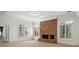 Bright living room with a brick fireplace, white trim, and natural light from shuttered windows at 9185 Old Southwick Pass, Johns Creek, GA 30022