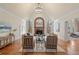 Inviting living room with hardwood floors, fireplace, and abundant natural light at 9185 Old Southwick Pass, Johns Creek, GA 30022