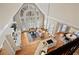 Open-concept living space with a kitchen island, living room, and dining area, flooded with natural light at 9185 Old Southwick Pass, Johns Creek, GA 30022