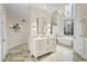 Elegant main bathroom features a standalone tub, high ceilings, and a marble tiled floor at 9185 Old Southwick Pass, Johns Creek, GA 30022