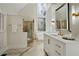 Light and airy main bathroom with glass enclosed shower and a marble-tiled floor at 9185 Old Southwick Pass, Johns Creek, GA 30022