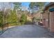 Brick house with a patio overlooking manicured yard at 9185 Old Southwick Pass, Johns Creek, GA 30022