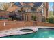 Beautiful in-ground pool and spa with brick and stone border in backyard at 9185 Old Southwick Pass, Johns Creek, GA 30022