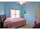 Airy bedroom with a vaulted ceiling, light blue walls, and a comfortable bed with pink coverlet at 1023 Hawk Creek Trl, Lawrenceville, GA 30043