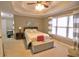 Bedroom with a large window, trey ceiling, neutral carpet, and ample space for a king-sized bed and seating area at 1023 Hawk Creek Trl, Lawrenceville, GA 30043