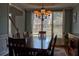 Formal dining room featuring a large window and chandelier at 1023 Hawk Creek Trl, Lawrenceville, GA 30043