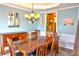 Elegant dining room with hardwood table, chairs, chandelier, and wainscoting at 1023 Hawk Creek Trl, Lawrenceville, GA 30043