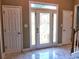 Attractive front entrance with decorative glass in the front door and marble flooring at 1023 Hawk Creek Trl, Lawrenceville, GA 30043