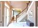 Inviting foyer with marble floors, a staircase with wood and white rails, and a view into other rooms at 1023 Hawk Creek Trl, Lawrenceville, GA 30043