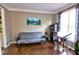 Comfortable living room featuring hardwood floors, a futon, and a writing desk at 1023 Hawk Creek Trl, Lawrenceville, GA 30043