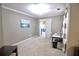 Sitting room featuring carpeted floors, a bright window, desk, and an open doorway at 1023 Hawk Creek Trl, Lawrenceville, GA 30043