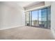 Bedroom with large windows offering city views and carpeted floors at 1065 Peachtree Ne St # 2901, Atlanta, GA 30309