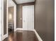 Hallway featuring dark hardwood floors, taupe-painted walls, and white trim at 1065 Peachtree Ne St # 2901, Atlanta, GA 30309