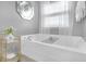 Stylish soaking tub area featuring modern fixtures, bright lighting, and elegant design at 120 Sunflower Ln, Covington, GA 30016