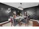 Elegant dining room with modern chandelier, dark walls, hardwood floors and seating for six at 120 Sunflower Ln, Covington, GA 30016