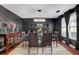 Elegant dining room with modern chandelier, dark walls, hardwood floors and seating for six at 120 Sunflower Ln, Covington, GA 30016