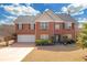 Charming two-story brick home with manicured lawn, attached two-car garage, and inviting front entrance at 120 Sunflower Ln, Covington, GA 30016