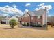 Two-story brick home with manicured lawn, attached two-car garage, separate building and inviting front entrance at 120 Sunflower Ln, Covington, GA 30016