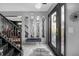 Elegant foyer with decorative mirrors, zebra rug, and staircase with ornate wrought iron railing at 120 Sunflower Ln, Covington, GA 30016