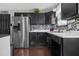 Stylish kitchen with stainless steel refrigerator and dark cabinets and mosaic backsplash at 120 Sunflower Ln, Covington, GA 30016