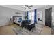 Comfortable bedroom featuring a ceiling fan, a mirror and black bedroom set at 120 Sunflower Ln, Covington, GA 30016