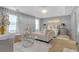 Serene main bedroom with plush chaise lounge, chandelier, and elegant decor at 120 Sunflower Ln, Covington, GA 30016