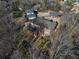 Aerial shot showcases the backyard and the architecture of the home, surrounded by mature trees at 2417 Siesta Ct, Marietta, GA 30062