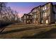 Dusk view of the backyard features a lush lawn and the home's rear elevation with large windows at 2417 Siesta Ct, Marietta, GA 30062