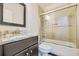 Bathroom featuring granite countertop, glass door shower, and dark cabinets at 2417 Siesta Ct, Marietta, GA 30062