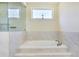 Bathroom featuring a tub with tile surround and a separate glass-enclosed shower at 2417 Siesta Ct, Marietta, GA 30062