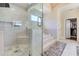 Bathroom featuring marble shower, marble floors, glass door, and a bathtub in a tiled alcove at 2417 Siesta Ct, Marietta, GA 30062